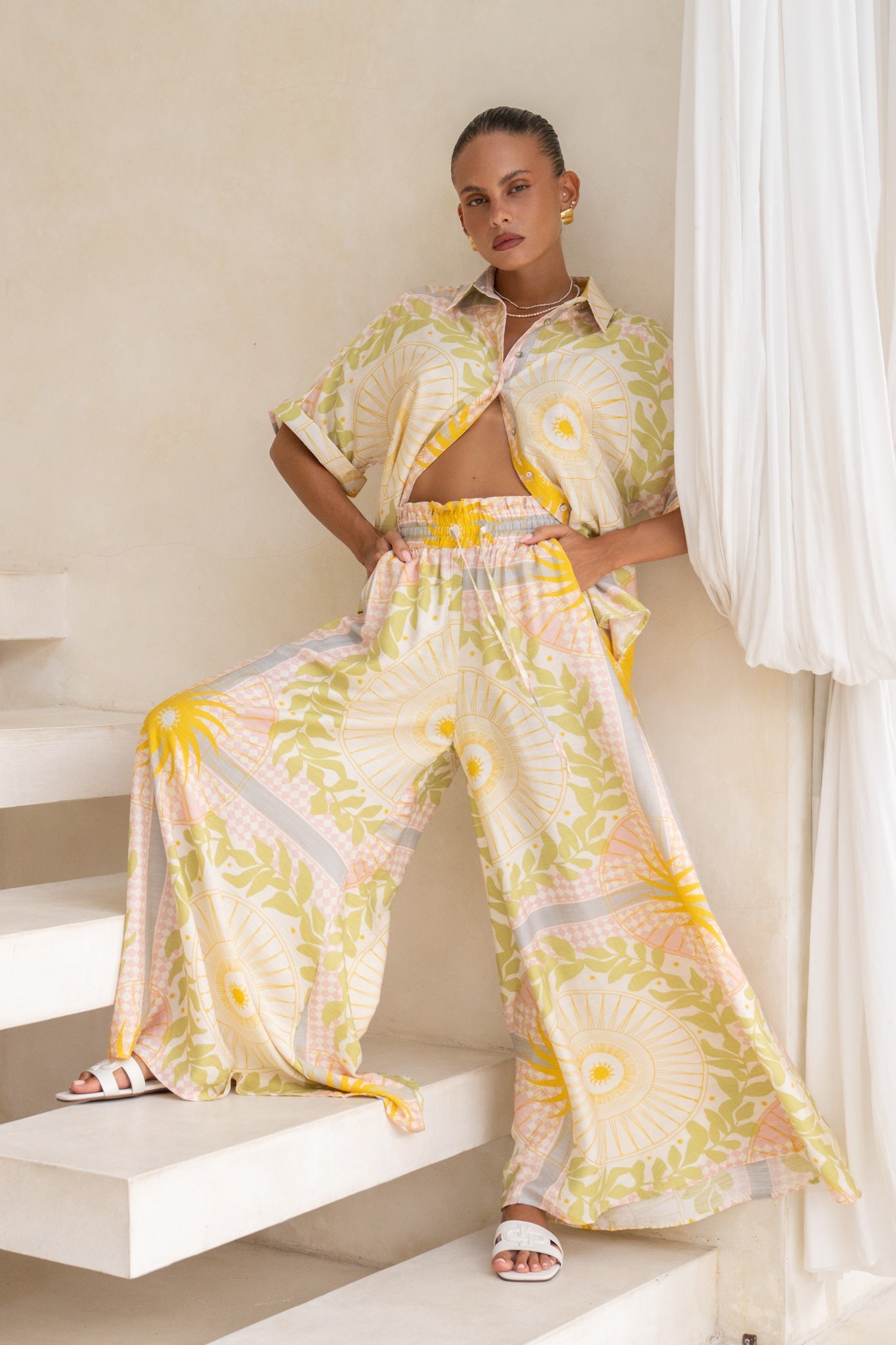 Image of a model wearing Pants. Productname: Heychic Aurea Pink Abstract Wide Leg Pants in Yellow colour by brand - Heychic