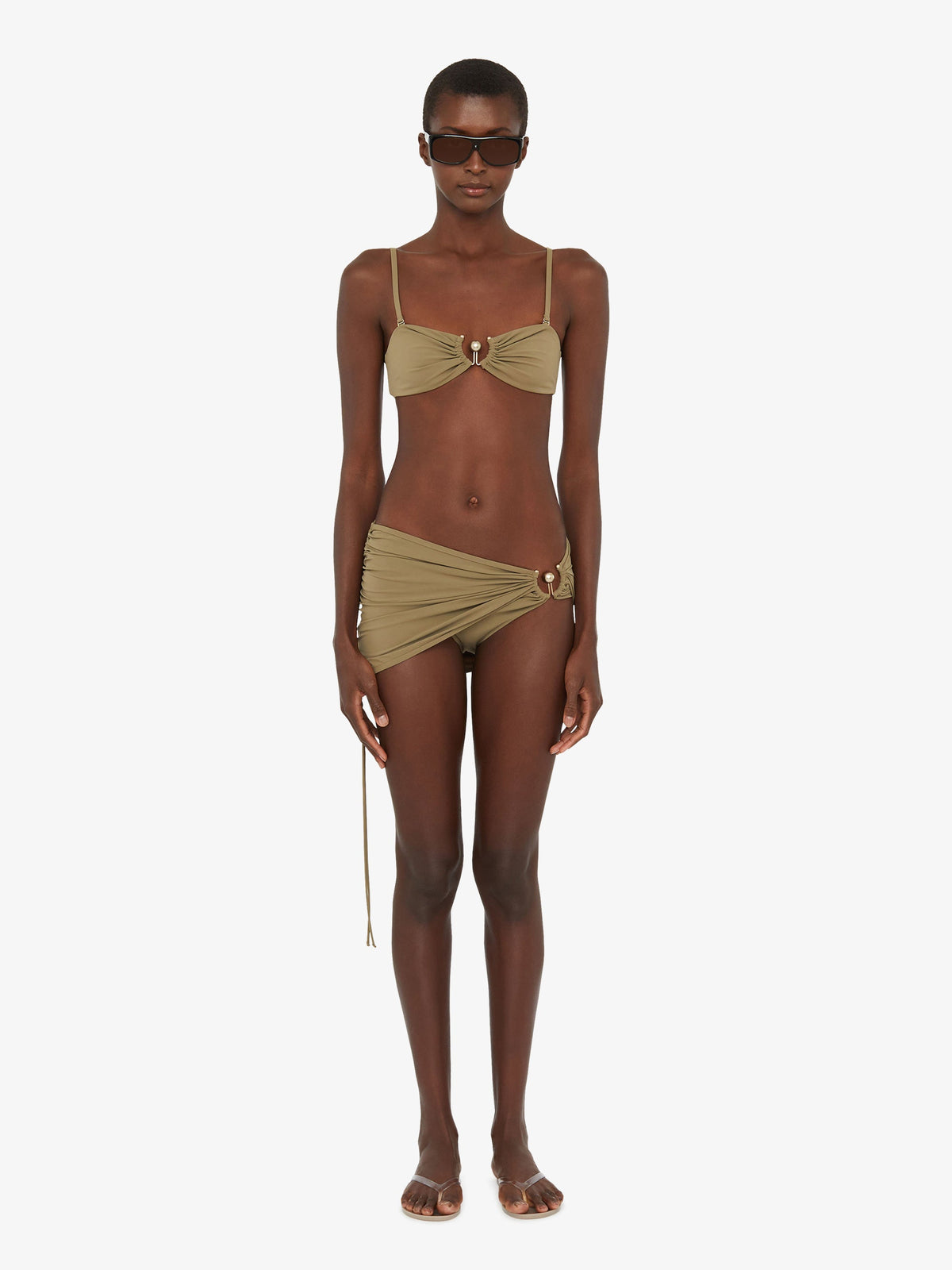 Image of a model wearing Skirts. Product name - Ruched Orbit Skirt Brief in Eucalypt colour by brand - Christopher Esber
