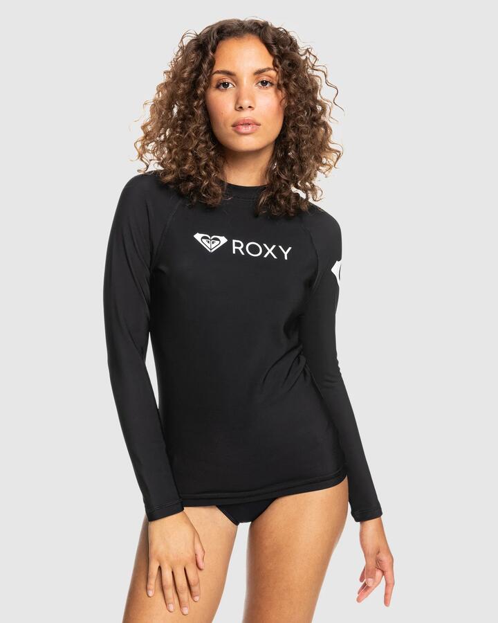 Image of a model wearing Tops. Product name - Roxy Womens Heater Long Sleeve Rash Vest Anthracite in Anthracite colour by brand - Roxy