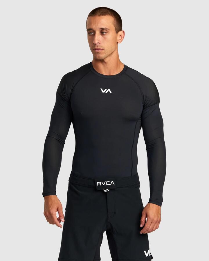 Image of a model wearing Tops. Product name - RVCA Mens Sport Long Sleeve Rash Vest Black in Black colour by brand - RVCA