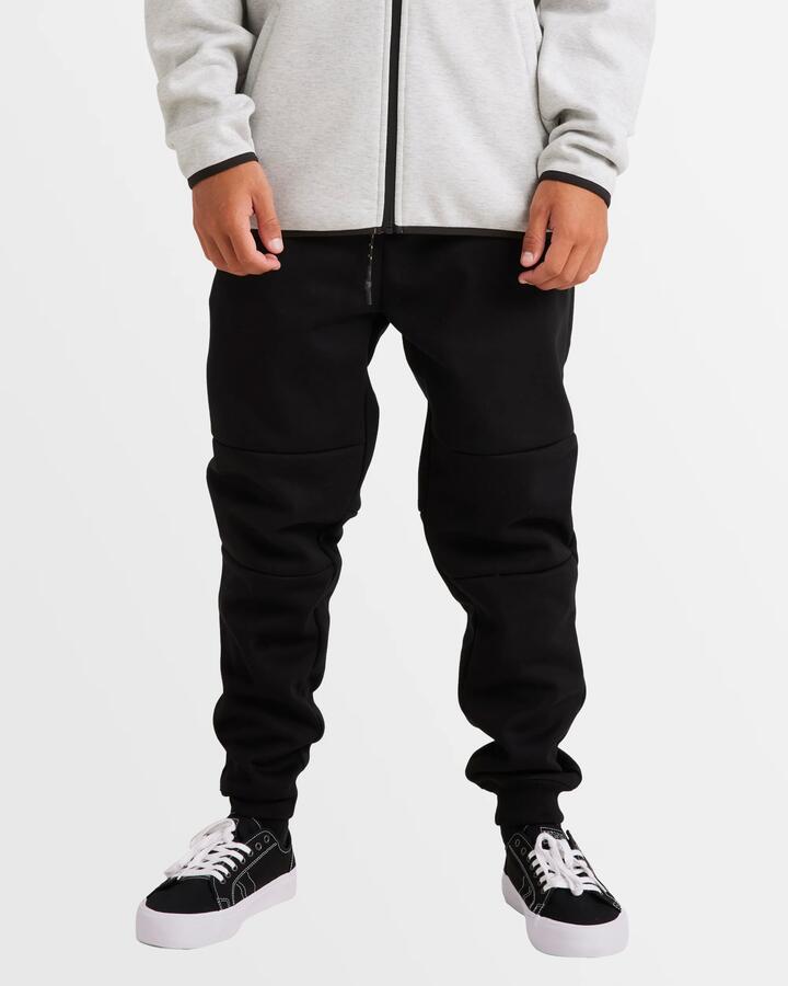 Image of a model wearing Outerwear. Product name - Billabong Mens Adiv Tech Fleece Sweat Pant Black in Black colour by brand - Billabong