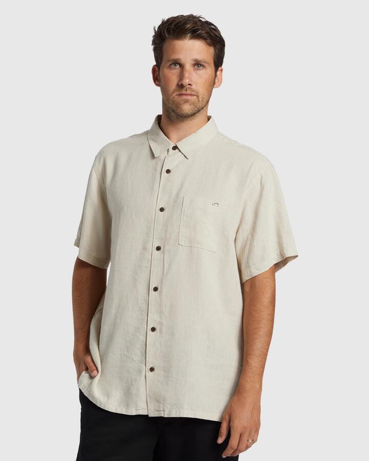 Image of a model wearing Tops. Product name - Billabong Mens Ricardo Short Sleeve Shirt Stone in Stone colour by brand - Billabong