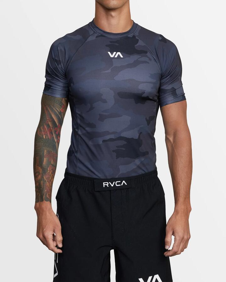 Image of a model wearing Tops. Product name - RVCA Mens Sport Short Sleeve Rash Vest Black Camo in Black Camo colour by brand - RVCA