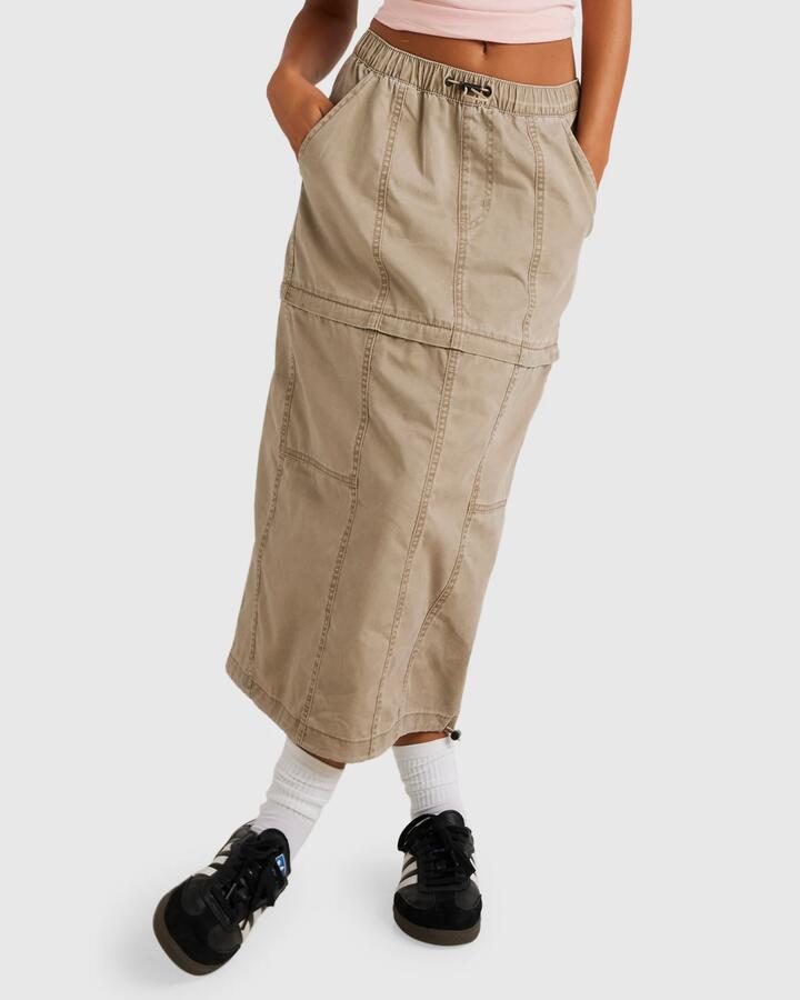 Image of a model wearing Skirts. Productname: RVCA Womens Stowaway Zip Off Midi Skirt Dark Khaki - in Dark Khaki colour by brand - RVCA