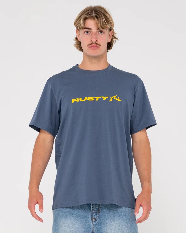 Image of a model wearing Tops. Productname: Rusty Mens Vital Rusty Short Sleeve T-Shirt China Blue - in China Blue colour by brand - Rusty