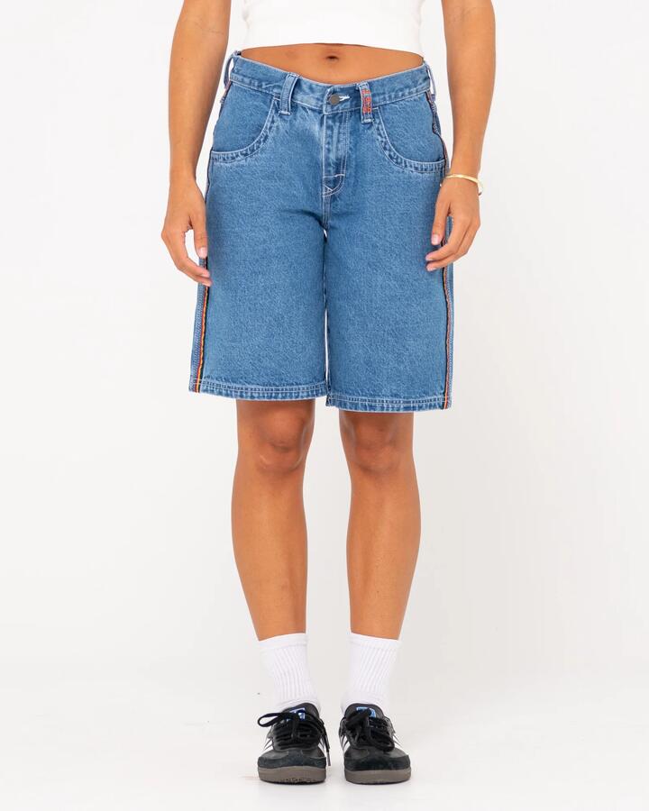 Image of a model wearing Shorts. Productname: Rusty Womens Flip Mommy Low Rise Wide Leg Denim Shorts Sea Blue/Red Gold - in Sea Blue/Red Gold colour by brand - Rusty