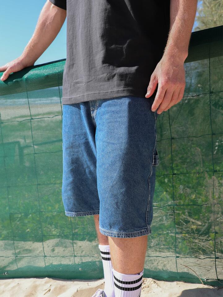 Image of a model wearing Shorts. Product name - Volcom Mens Labored Denim Utility Denim Short Indigo Ridge Wash in Indigo Ridge Wash colour by brand - Volcom
