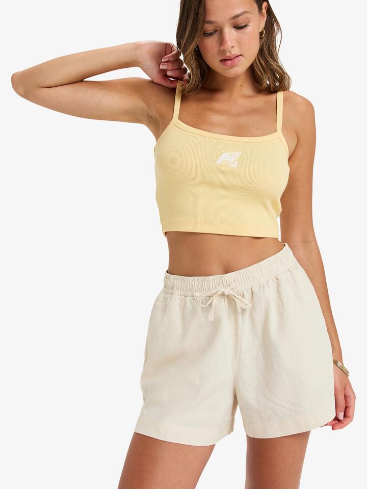 Image of a model wearing Shorts. Product name - Roxy Womens Lekeitio Break Mid Elastic Waist Shorts Parchment in Parchment colour by brand - Roxy