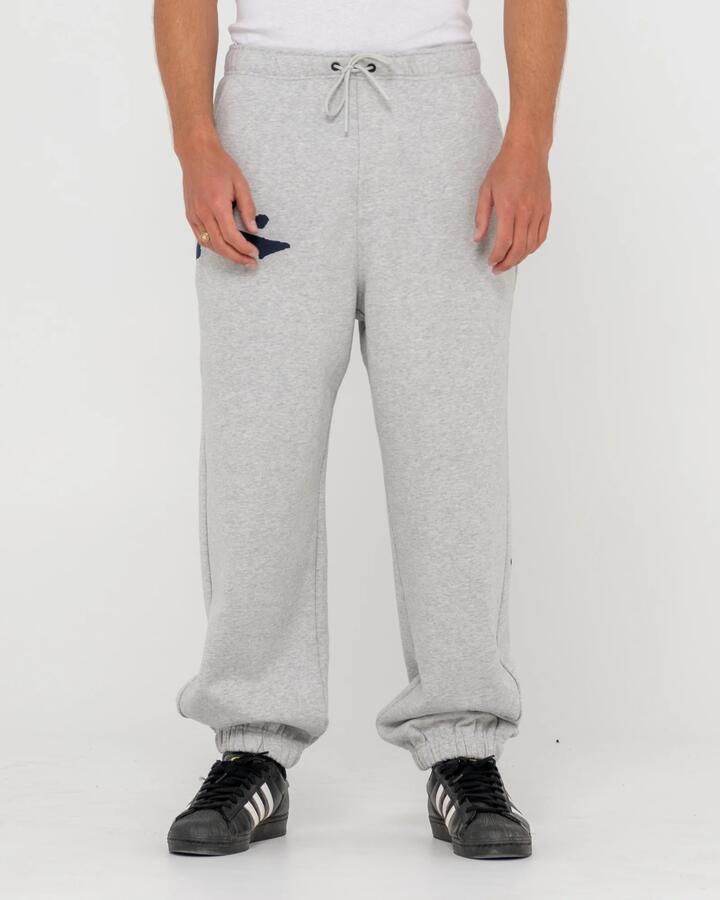 Image of a model wearing Pants. Productname: Rusty - Mens Competition Revolution Track Pants - Grey Marle - in Grey Marle colour by brand - Rusty