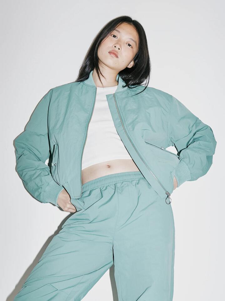 Image of a model wearing Outerwear. Productname: Beyond Her Chicago Bomber Jacket in Pine colour by brand - Beyond Her