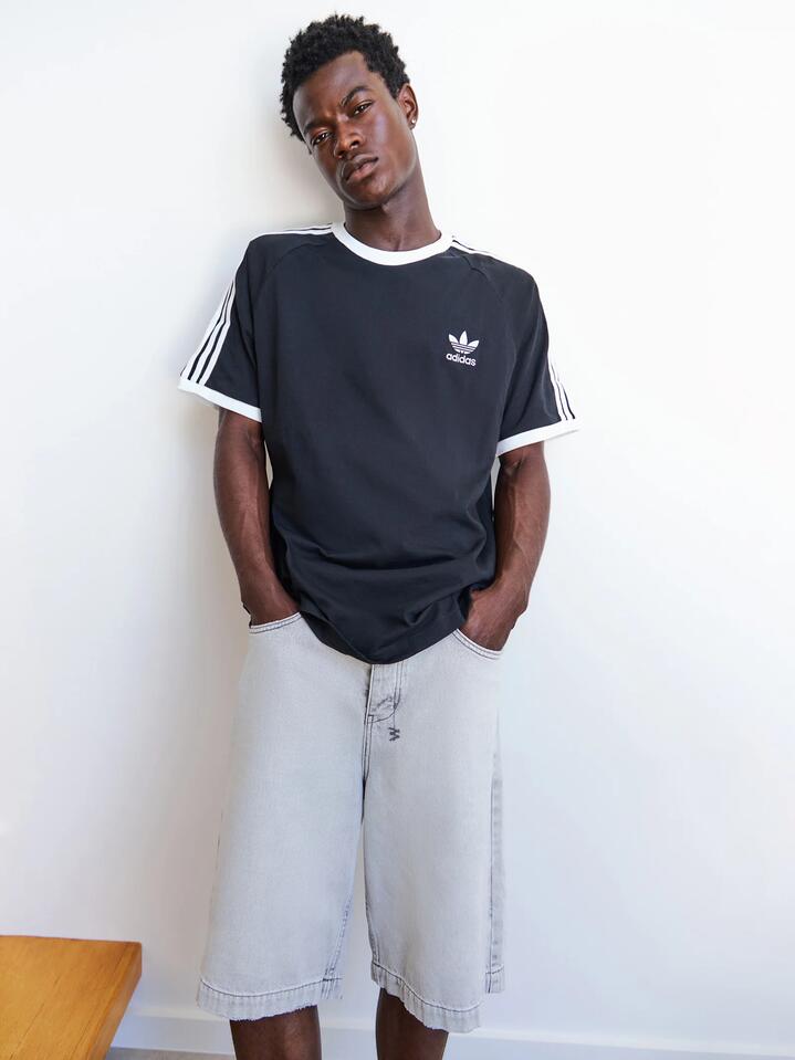 Image of a model wearing Tops. Productname: Adidas Adicolor Classics 3 Stripes T-Shirt in Black colour by brand - Adidas