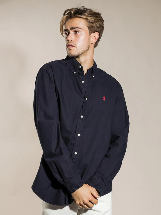 Image of a model wearing Tops. Productname: Polo Ralph Lauren Standard Fit Button Up Shirt in Navy colour by brand - Polo Ralph Lauren