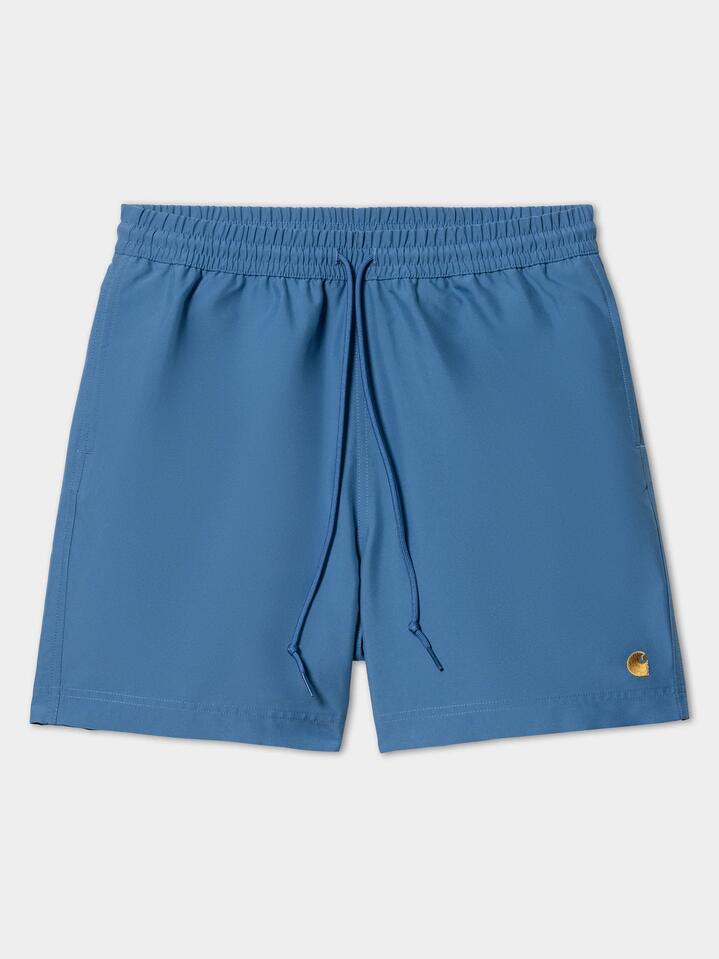 Image of a model wearing Shorts. Productname: Carhartt Wip Chase Swim Trunks in Acapulco/Gold colour by brand - Carhartt Wip