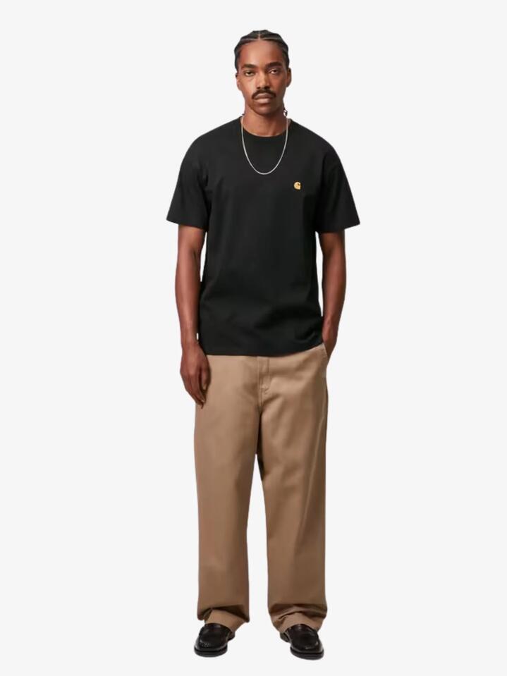 Image of a model wearing Tops. Productname: Carhartt Wip Short Sleeve Chase T-Shirt in Black/Gold colour by brand - Carhartt Wip
