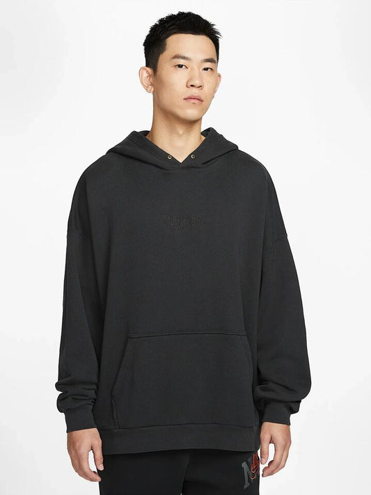 Image of a model wearing Outerwear. Productname: Nike Oversized French Terry Pullover Hoodie in Off Noir/Off Noir colour by brand - Nike