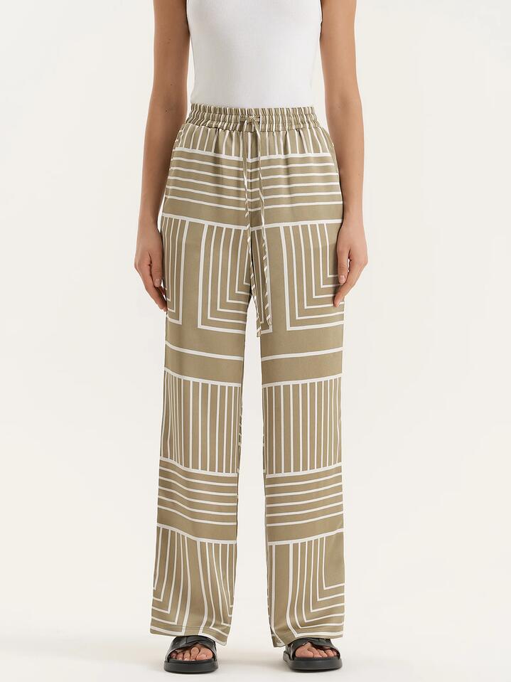 Image of a model wearing Pants. Productname: 4th & Reckless Amira Trouser in Sage Print colour by brand - 4th & Reckless