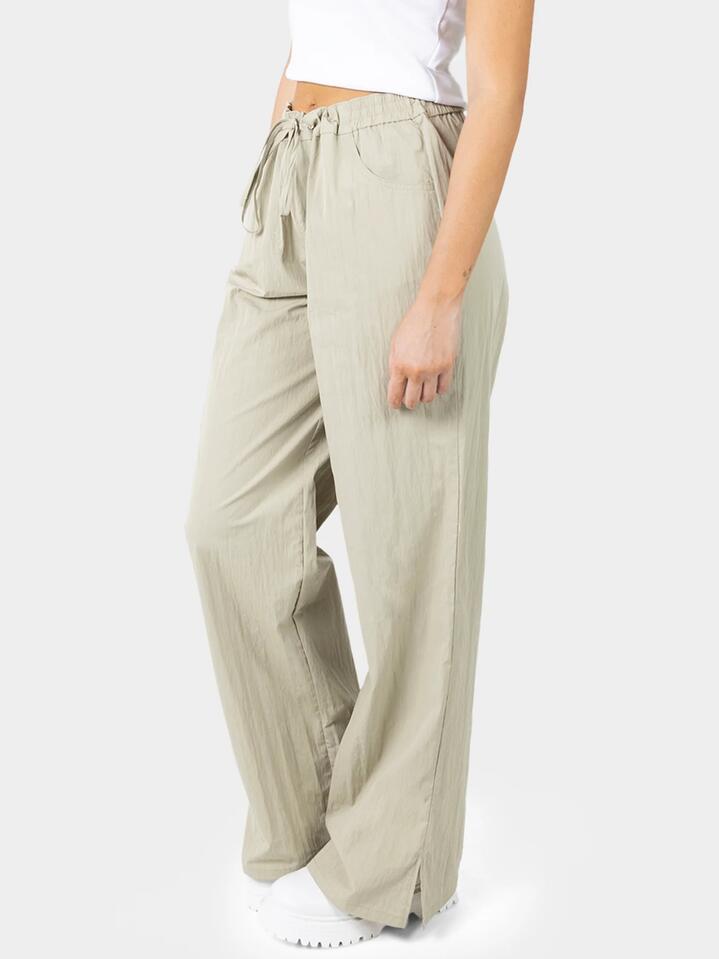 Image of a model wearing Pants. Productname: Dickies Parachute Pant in Khaki colour by brand - Dickies
