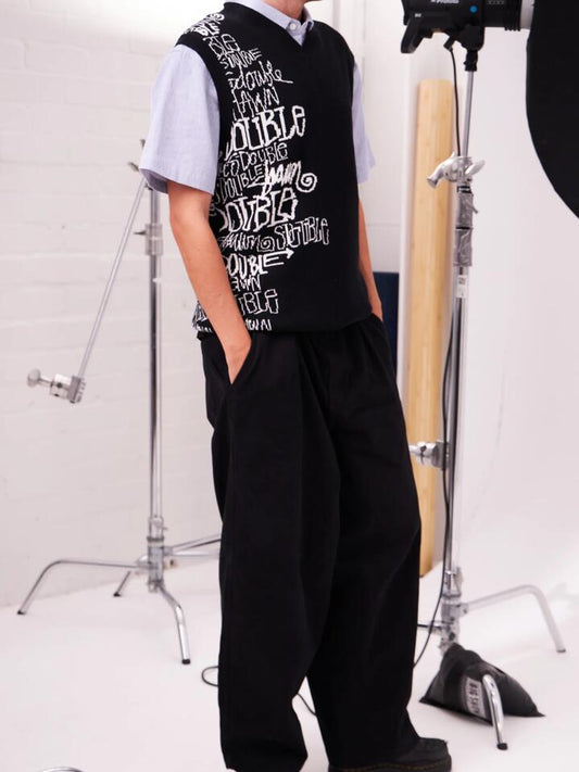 Image of a model wearing Outerwear. Productname: S-Double Script Stack Sweater Vest in BLACK colour by brand - S-Double