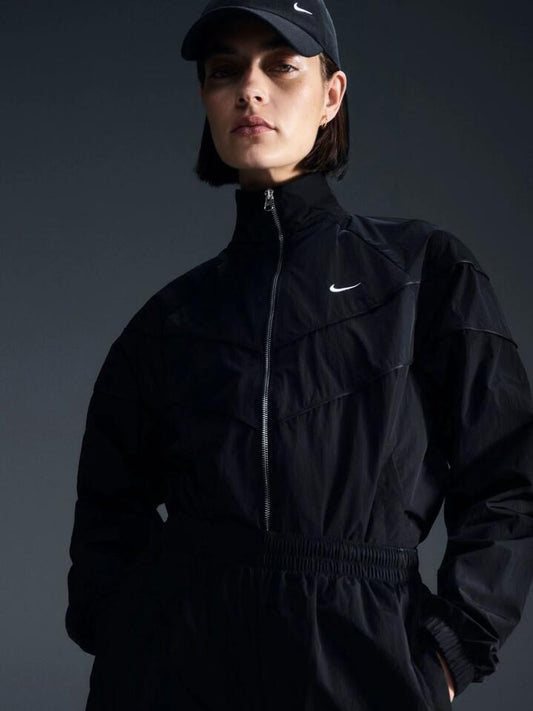 Image of a model wearing Outerwear. Productname: Nike Women's Loose UV Woven Full-Zip Jacket in Black/White colour by brand - Nike