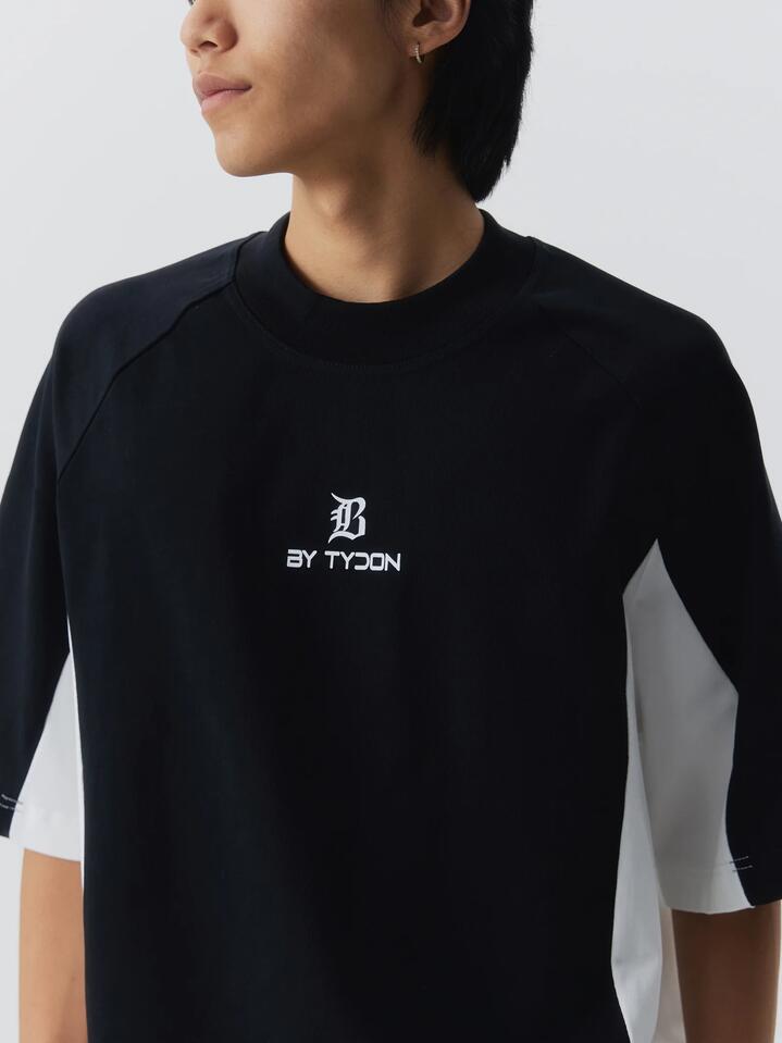 Image of a model wearing Tops. Productname: By Tydon Panel T-Shirt in BLACK/WHT colour by brand - By Tydon