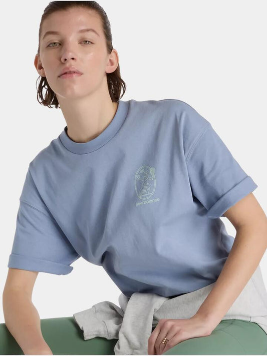 Image of a model wearing Tops. Productname: New Balance New Balance X Debut Vase Tee in Dusk Shower colour by brand - New Balance