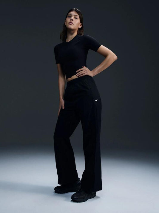 Image of a model wearing Pants. Productname: Nike Women's High-Waisted Woven Open-Hem Pants in Black/White colour by brand - Nike