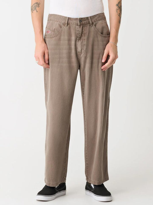 Image of a model wearing Denim. Productname: Xlarge Bull Denim 91 Pants in Worn Brown colour by brand - Xlarge