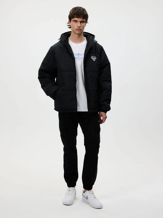 Image of a model wearing Outerwear. Productname: Henleys Hooded Puffer in Black colour by brand - Henleys