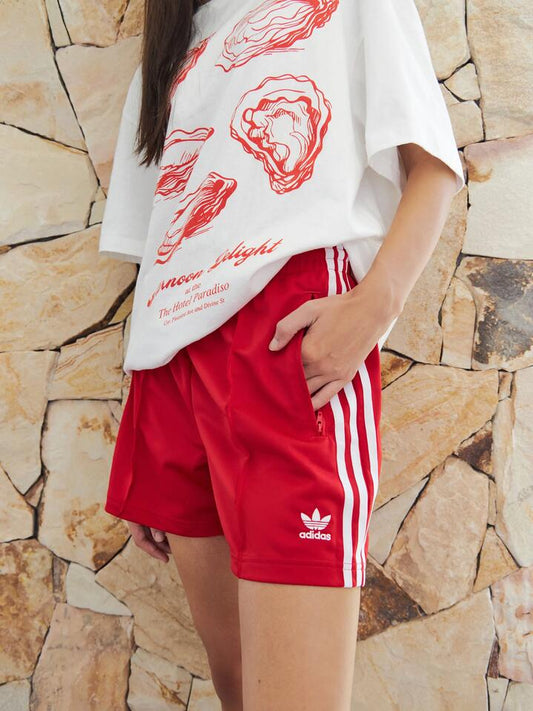 Image of a model wearing Shorts. Productname: Adidas Firebird Short in Better Scarlet/White colour by brand - Adidas