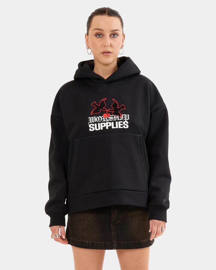Image of a model wearing Outerwear. Productname: Worship - Womens Love Birds Box Fit Pullover Hoodie - Black - in Black colour by brand - Worship