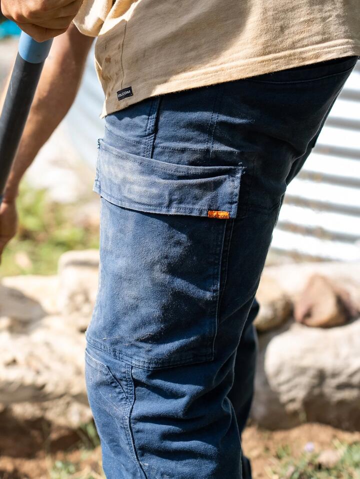 Image of a model wearing Pants. Product name - Volcom Mens Caliper Cuffed Carpenter Pants Navy in Navy colour by brand - Volcom