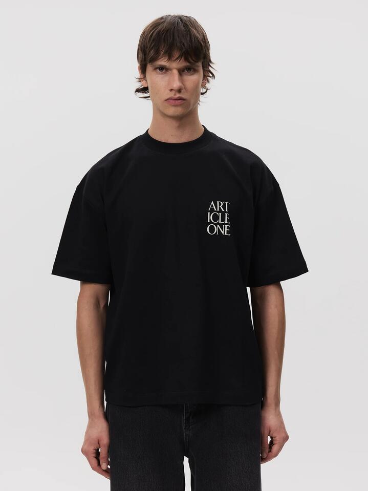 Image of a model wearing Tops. Productname: Article One Lockup Logo Tee in Black colour by brand - Article One