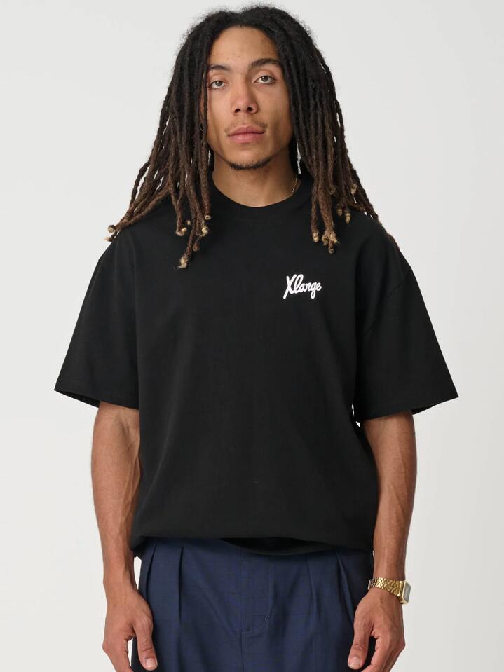 Image of a model wearing Tops. Productname: Xlarge Folded Crown Tee in SOLID BLACK colour by brand - Xlarge