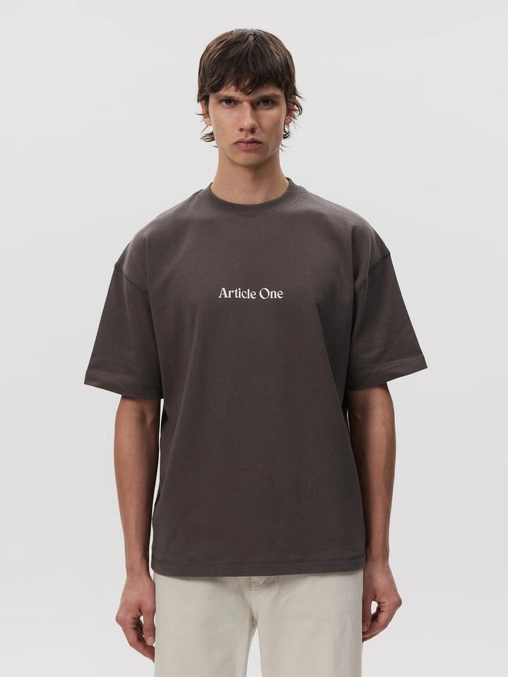 Image of a model wearing Tops. Productname: Article One Mariposa Logo Tee in Obsidian colour by brand - Article One