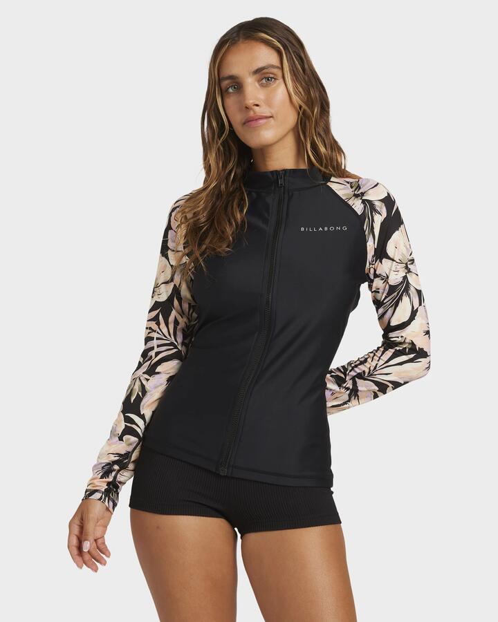 Image of a model wearing Tops. Product name - Billabong Womens Drifting Coast Upf 50 Long Sleeve Rash Vest Black Floral in Black Floral colour by brand - Billabong