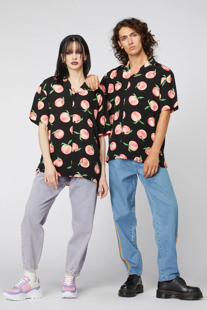 Image of a model wearing Tops. Productname: Peachy Print Unisex Shirt in Black colour by brand - Dangerfield