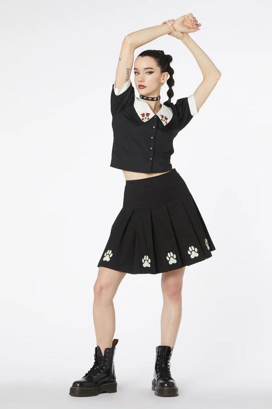 Image of a model wearing Skirts. Productname: Flock Paw Print Pleat Skirt in Black colour by brand - Dangerfield