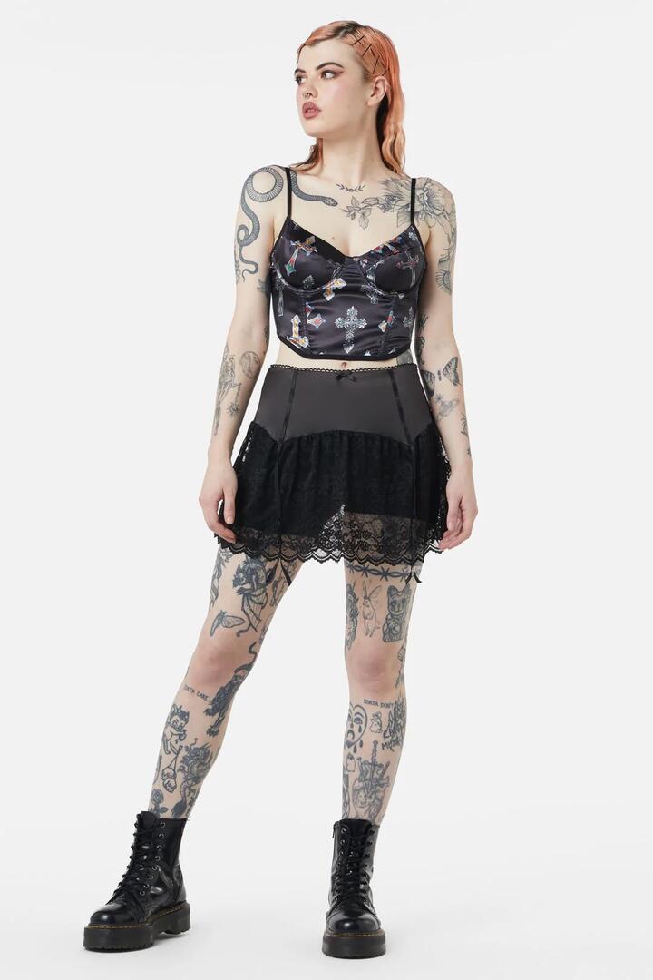 Image of a model wearing Skirts. Productname: Boudoir Satin Lace Skort in Black colour by brand - Dangerfield