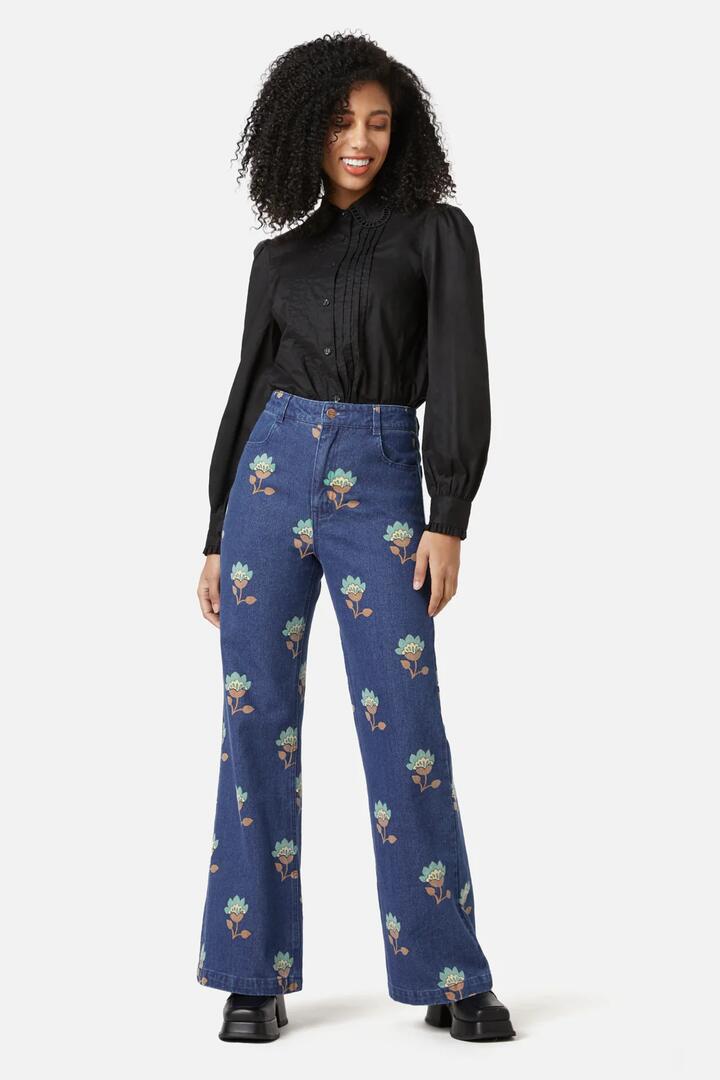 Image of a model wearing Denim. Productname: Retro Flora Flare Jean in Dark Denim colour by brand - Princess Highway