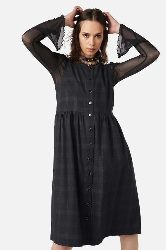 Image of a model wearing Dress. Productname: High Society Tartan Pinny Dress in Black colour by brand - Dangerfield