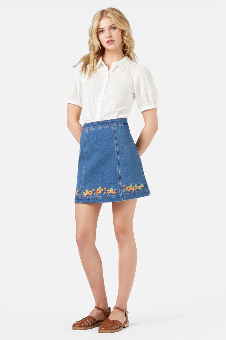 Image of a model wearing Skirts. Productname: Emb Nasturtium Mini Skirt in Mid Denim colour by brand - Princess Highway