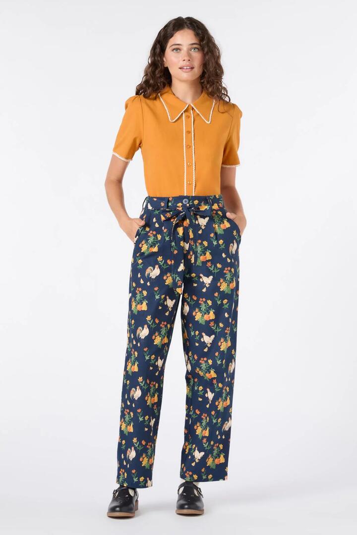 Image of a model wearing Pants. Productname: Chickens Tapered Pant in Navy colour by brand - Princess Highway