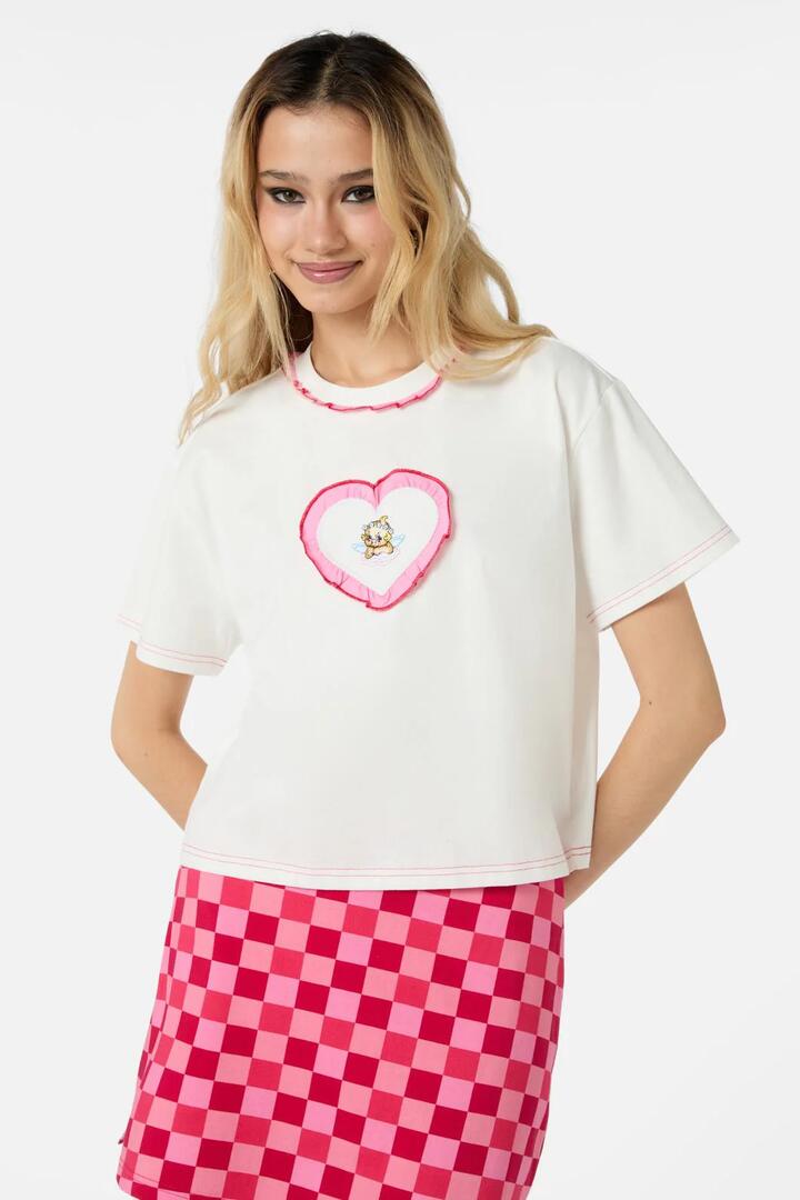 Image of a model wearing Tops. Productname: Cupid Crop OS Tee in White colour by brand - Dangerfield