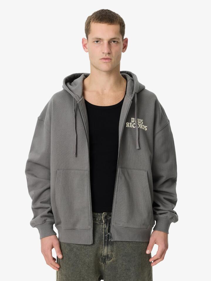 Image of a model wearing Outerwear. Productname: Deus No. 13 Baby Zip Hoodie in Charcoal colour by brand - Deus