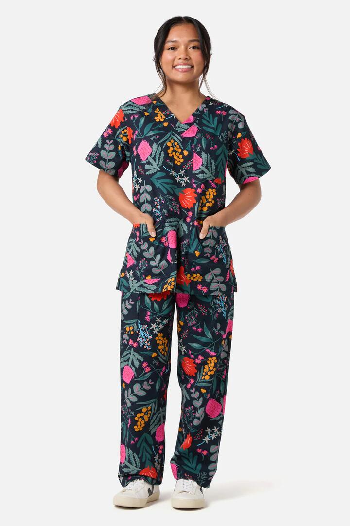 Image of a model wearing Uniforms & Workwear. Productname: Eva Native Scrub Set in Navy colour by brand - Scrubs With Love