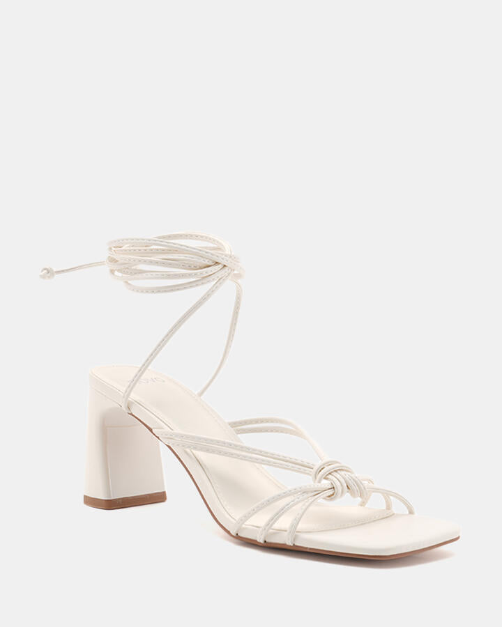 Image of Heels. Product name - Urijah White Block Heels in Multi colour by brand - Novo