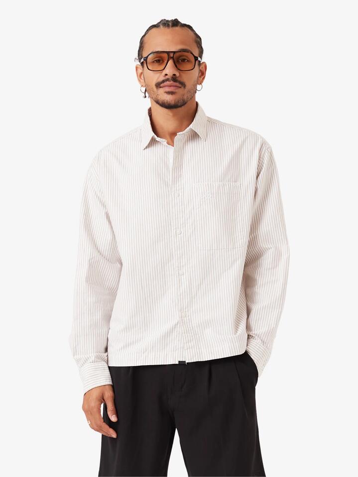 Image of a model wearing Tops. Productname: Zanerobe Overlap Crop Ls Shirt - White Pinstripe in White Pinstripe colour by brand - Zanerobe