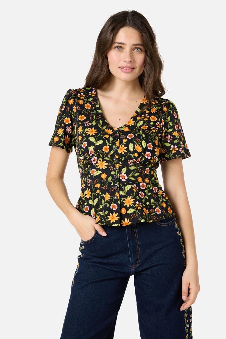 Image of a model wearing Tops. Productname: Alyssa Floral Peplum Top in Black colour by brand - Princess Highway