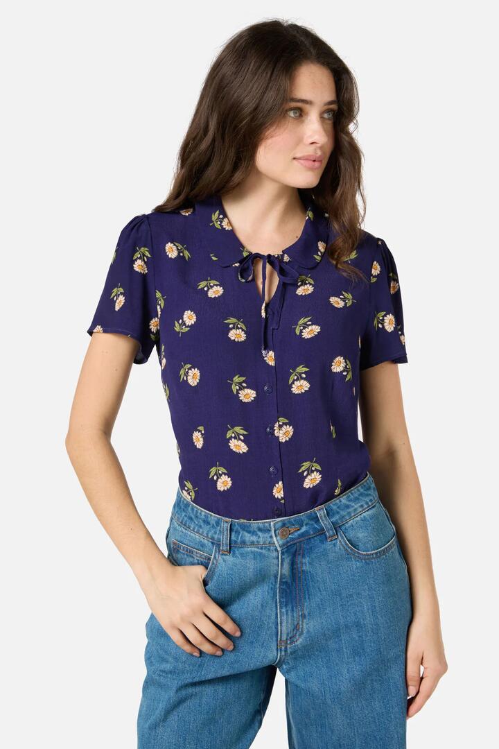 Image of a model wearing Tops. Productname: Marguerite Daisy Blouse in Navy colour by brand - Princess Highway