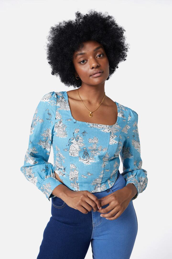 Image of a model wearing Tops. Productname: Skelly Toile Puff Sleeve Top in Dusty Blue colour by brand - Dangerfield